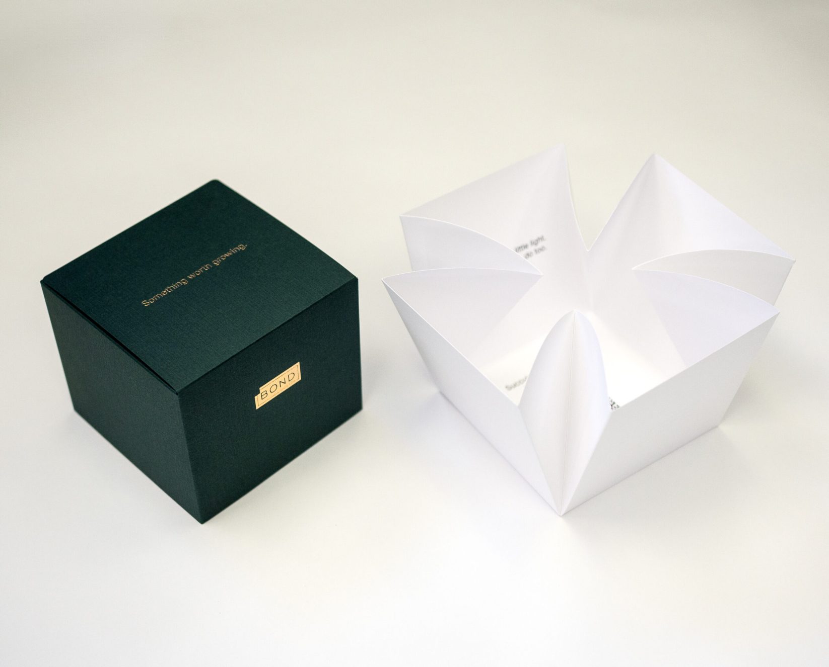 Custom die cutting in Vancouver - close up image of a specialty box with Bond Reproductions logo in gold foil.