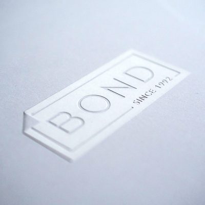 Custom finishing services - embossing Bond Reproductions logo.